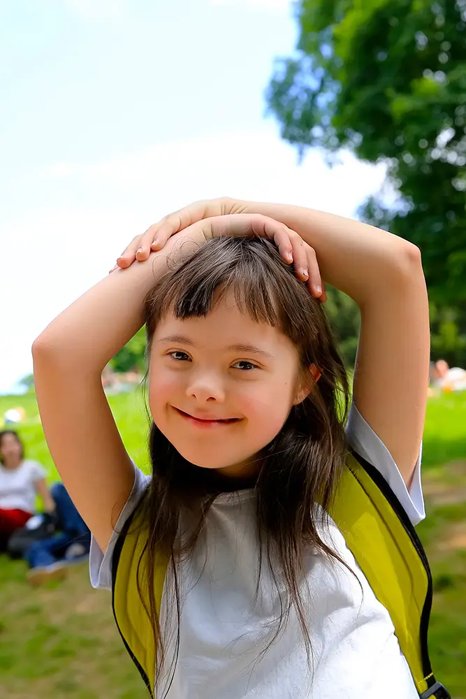 smiling girl with Down Syndrome in the park