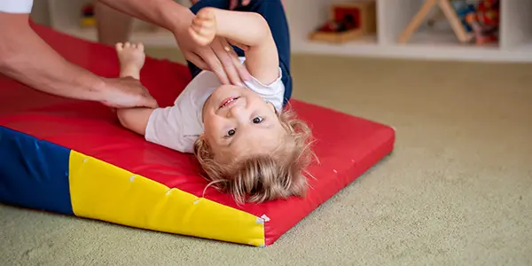 Young boy with cerebral palsy doing therapy