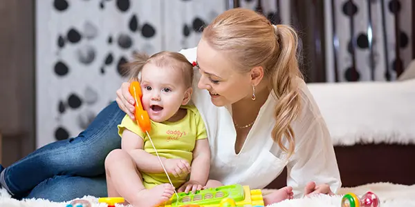 mother and her young child playing with a toy phone